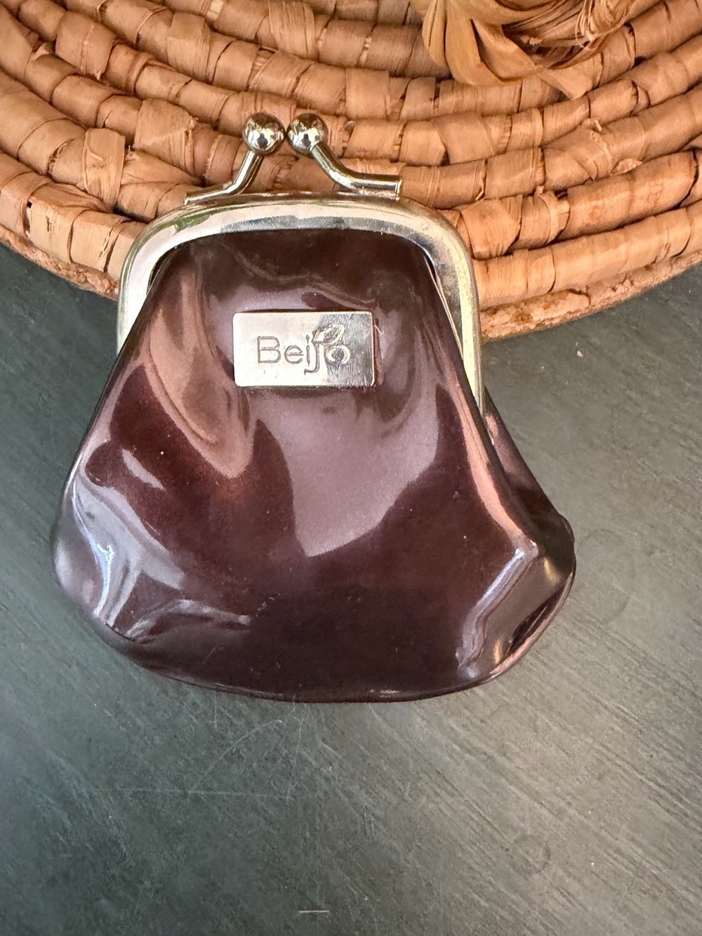 Beijo patent leather coin purse features a dark chocolate brown